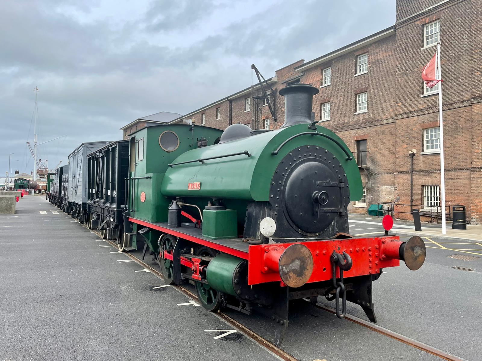 AJAX, a green steam locomotive, with Dockyard railway wagons at Chatham