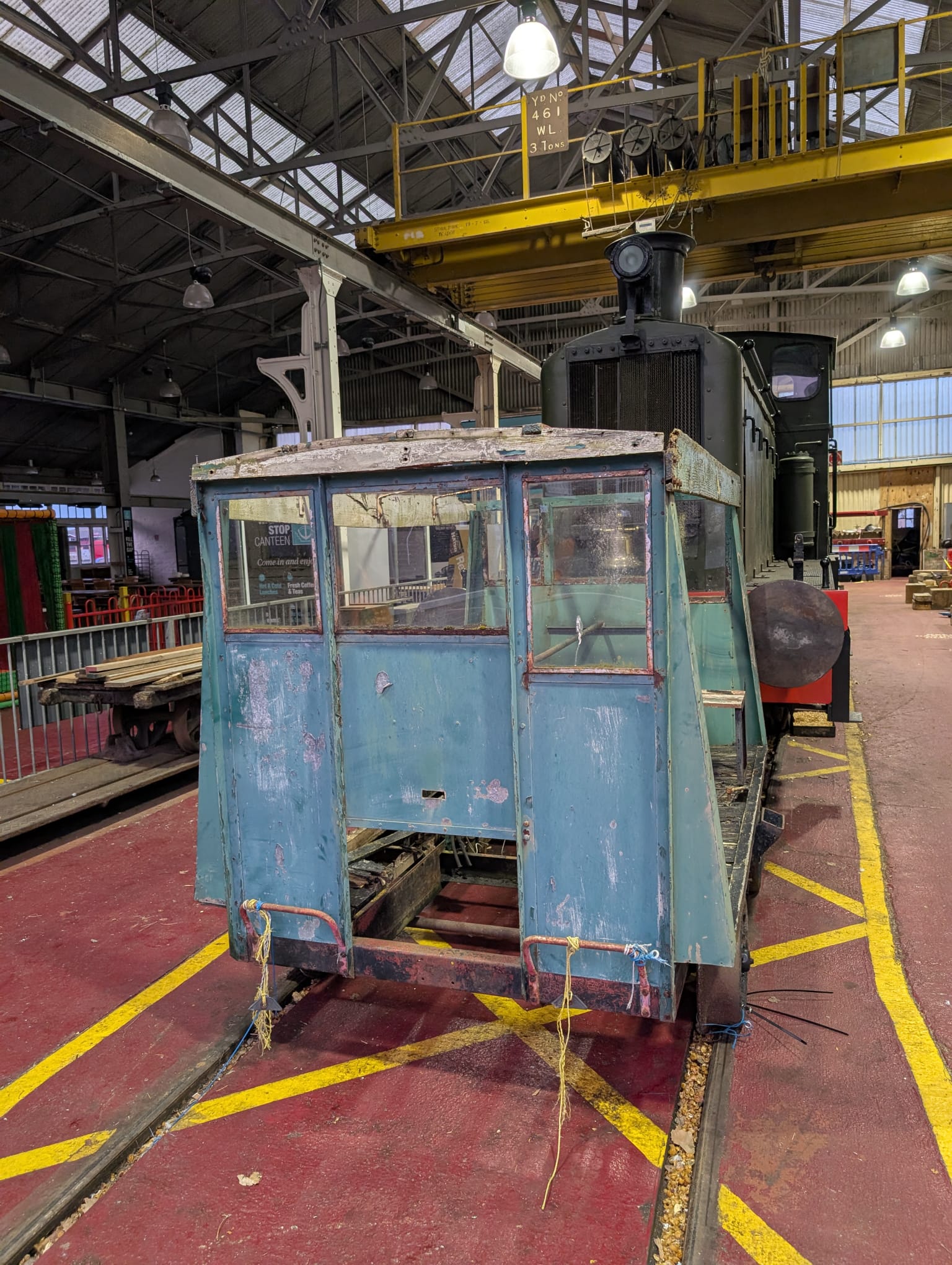Wickham trolley inside the workshop beside a locomotive